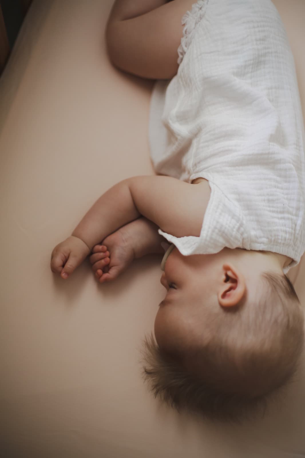 A baby sleeping peacefully in a crib