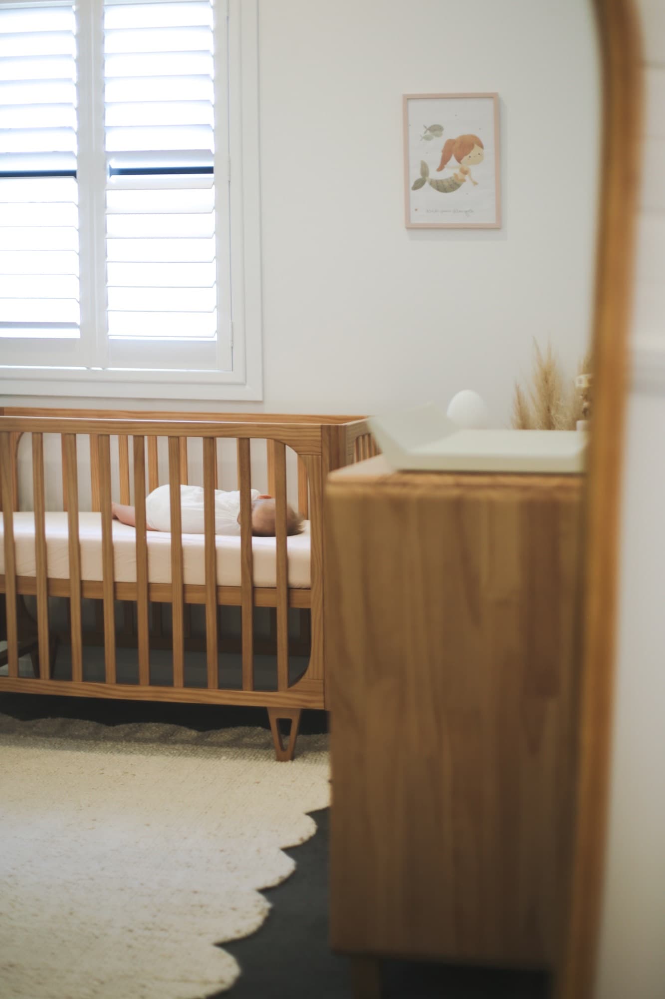 Peaceful nursery with a baby sleeping in a wooden crib